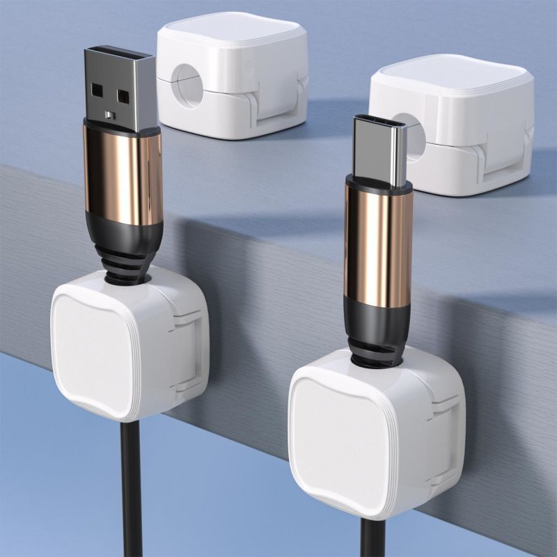Vita kabelklämmor med USB-kablar på bordskanten